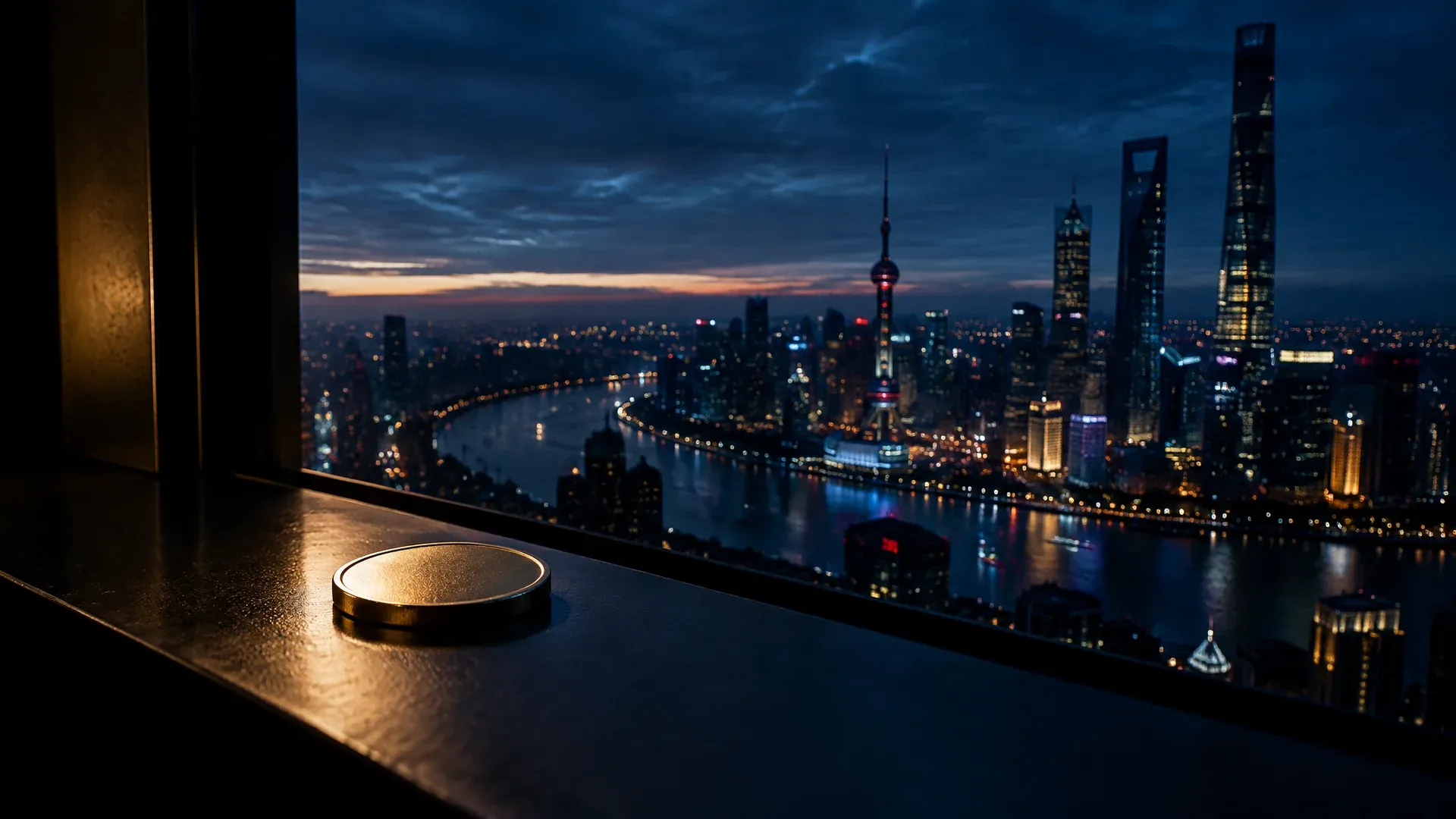 Skyline of an Asian financial district before dawn with a coin on the window sill