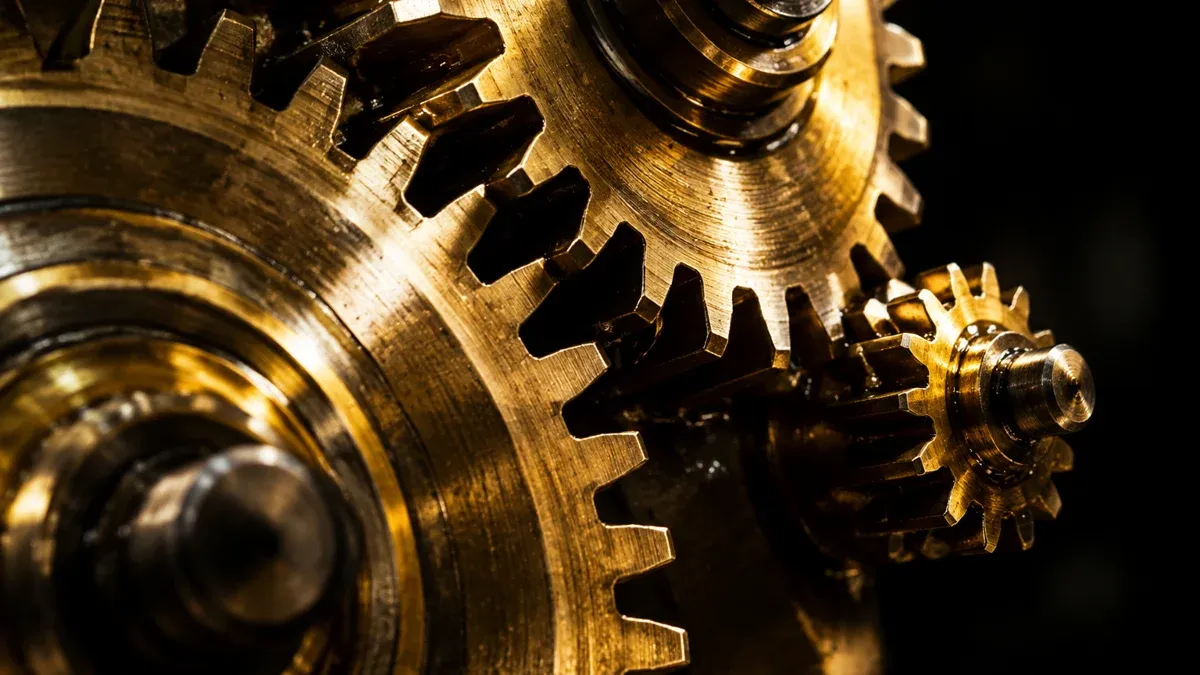 Macro shot of a brass gear train in which a smaller cog taps off the movement at the edge