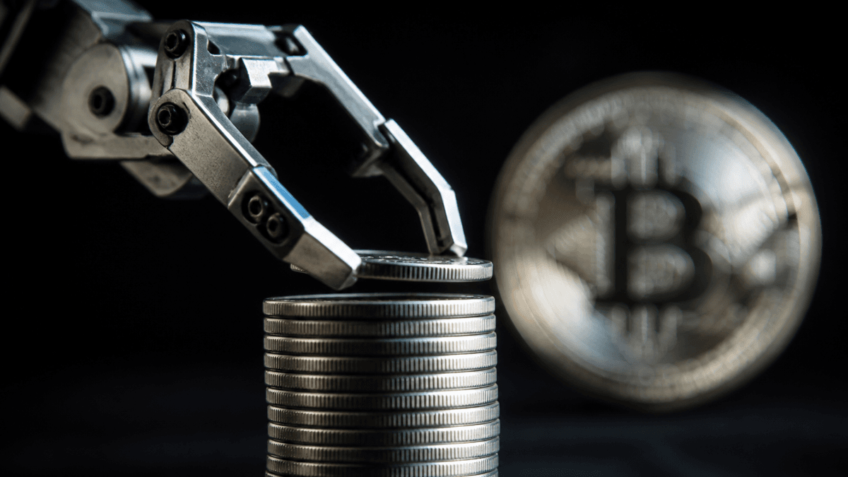 Mechanical gripper arm pulling a single silver coin out of a stack of coins